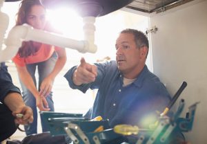 Plumber explaining a plumbing issue to a homeowner Sarasota, FL